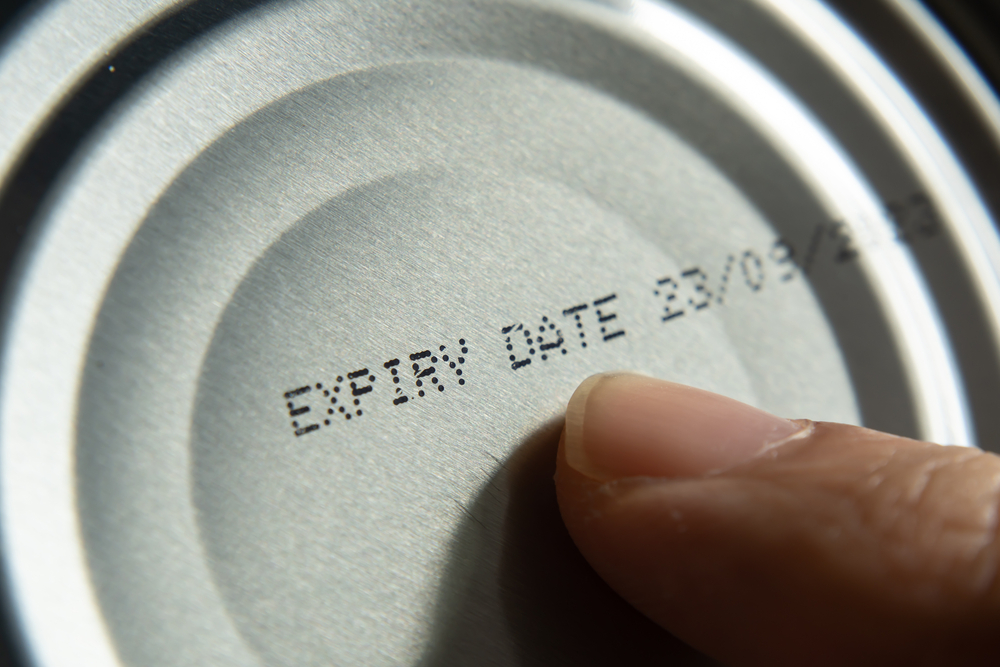 Finger,Pointing,At,The,Expiry,Date,On,Canned,Food